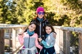 Portrait of family visiting wooden treetop observation deck walkway