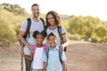 Portrait Of Family Wearing Backpacks Hiking In Countryside Together Royalty Free Stock Photo