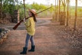 Portrait the farmer asea woman wearing a hat hand holding muzzle-loading vintage gun in the farm, Young girl with air rifle a Royalty Free Stock Photo