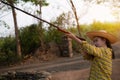 Portrait the farmer asea woman wearing a hat at the shooting range shot from a muzzle-loading vintage gun in the farm, Young girl Royalty Free Stock Photo