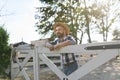 Portrait of farmer leaning agaist wooden fence, looking at his farm. Man with hat working on family ranch. Royalty Free Stock Photo