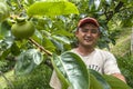 portrait of farmer on peaches fruit orchard