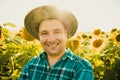 portrait of farmer in a sunflower field and looking at camera. Royalty Free Stock Photo