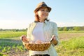 Portrait of farmer woman in hat with basket of fresh egg Royalty Free Stock Photo
