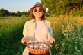 Portrait of farmer woman in hat with basket of fresh egg Royalty Free Stock Photo