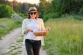 Portrait of farmer woman in hat with basket of fresh egg Royalty Free Stock Photo