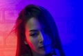 Portrait fashion of an Asian woman in neon-violet and red light  that shines in the dark with beauty and sexy, seductive, charming Royalty Free Stock Photo