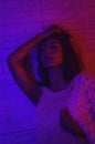 Portrait fashion of an Asian woman in neon-violet and red light  that shines in the dark with beauty and sexy, seductive, charming Royalty Free Stock Photo