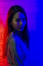Portrait fashion of an Asian woman in neon-violet and red light  that shines in the dark with beauty and sexy, seductive, charming Royalty Free Stock Photo
