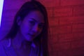 Portrait fashion of an Asian woman in neon-violet and red light  that shines in the dark with beauty and sexy, seductive, charming Royalty Free Stock Photo