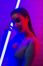 Portrait fashion of an Asian woman in neon-violet and red light  that shines in the dark with beauty and sexy, seductive, charming Royalty Free Stock Photo