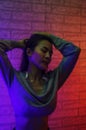 Portrait fashion of an Asian woman in neon-violet and red light  that shines in the dark with beauty and sexy, seductive, charming Royalty Free Stock Photo