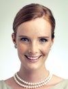 Portrait, fashion and beauty of happy woman in studio with vintage pearl necklace isolated on a gray background. Face Royalty Free Stock Photo