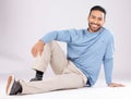 Portrait, fashion and happy man on the floor in studio isolated on a white background. Style, smile and Asian person Royalty Free Stock Photo