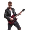 Portrait of fashion man playing his electric guitar Royalty Free Stock Photo