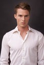 Portrait, fashion and a masculine young model in studio on a dark background in an open collar shirt. Cool, clothing and Royalty Free Stock Photo