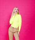Portrait of fashion smiling blonde model girl young woman wearing stylish  on a pink Royalty Free Stock Photo