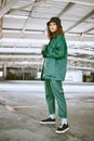 Portrait, fashion or stylish young gen z woman stand in a warehouse with green clothing. Trendy, hipster latino girl Royalty Free Stock Photo