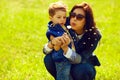 Portrait of fashionable baby boy and mum with dandelion Royalty Free Stock Photo