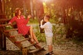 Happy child blowing dandelion outdoors in spring park Royalty Free Stock Photo