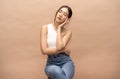 Portrait of fashionable beautiful young sexy Asian woman with natural make-up sitting on a chair and closed eyes.  Lady slim wears Royalty Free Stock Photo