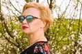 Portrait of fashionable blonde woman posing wearing shades Royalty Free Stock Photo