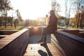 Portrait of fashionable well dressed man posing outdoors looking away, confident and focused man in coat sitting outside Royalty Free Stock Photo