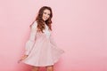 Portrait of a beautiful fashionable woman with hair curls in a pink dress Royalty Free Stock Photo
