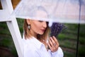 Portrait of fashionable woman with unusual earring in ear under transparent umbrella. shallow depth of field photo Royalty Free Stock Photo