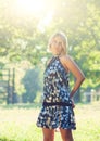 Portrait of fashionable young sensual blonde woman in garden enyoing on the grass field