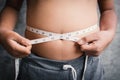 Portrait fat boy measuring tape of stomach Royalty Free Stock Photo