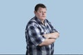 Portrait of a fat man in a shirt on a blue background