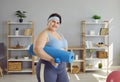 Portrait of fat woman going to do sport exercises with dumbbell, yoga mat at home. Royalty Free Stock Photo