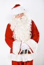 Portrait of father Christmas in studio with white background in a red costume for Christian winter holiday celebration Royalty Free Stock Photo