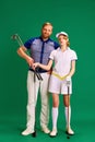 Portrait of father and daughter on golf court. Dad, man and girl, teenager dressed like golf players posing with golf Royalty Free Stock Photo