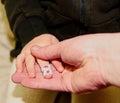 Portrait of father and daughter holding hand in hand. Girl child with sticking plaster on finger. Concept idea. Family Royalty Free Stock Photo