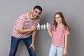 Father and daughter holding paper chain people together, happy family, relationships, childhood. Royalty Free Stock Photo