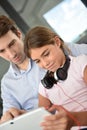 Portrait of father and daughter using digital tablet at home Royalty Free Stock Photo