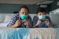 Father and son playing video game with mask Royalty Free Stock Photo