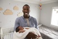Portrait Of Father Holding Newborn Baby Son In Nursery Royalty Free Stock Photo
