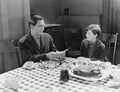 Portrait of father and son at dinner table Royalty Free Stock Photo