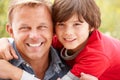 Portrait father and son outdoors