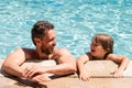 Portrait of father and son relax in swimming pool. Pool resort. Happy family face. Copy space. Royalty Free Stock Photo