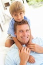 Portrait Of Father And Son Relaxing On Sofa Royalty Free Stock Photo