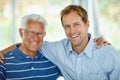 Like father, like son. Portrait of a father and son sitting together. Royalty Free Stock Photo