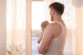 Portrait of father standing near the window with baby Royalty Free Stock Photo
