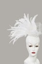 Feather fascinator on mannequin against gray background Royalty Free Stock Photo