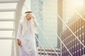 Portrait of feeling strain Arab Middle Eastern Businessman using smartphone in the city background, Success Business concept