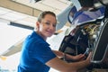 Portrait Of Female Aero Engineer Working On Helicopter In Hangar