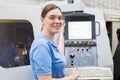 Portrait Of Female Apprentice Engineer Operating CNC Machine In Royalty Free Stock Photo